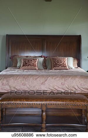 Stock Photograph - Leather bench at foot of master bed; Porterville; California; USA. Fotosearch