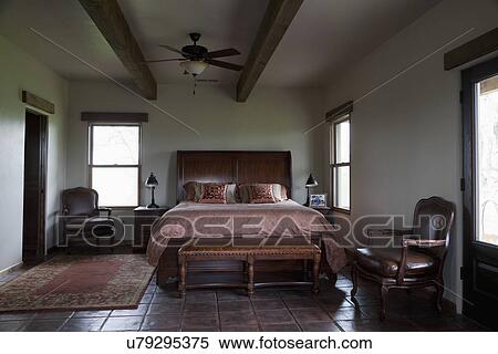 Leather bench at foot of master bed; Porterville; California; USA View Large Photo Image Stock Photography - Leather bench at foot of master bed; Porterville; California; USA. Fotosearch