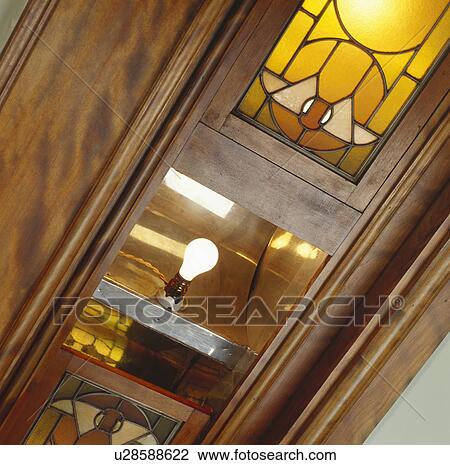 Light bulb lit in wooden cabinet View Large Photo Image Stock Image - Light bulb lit in wooden cabinet. Fotosearch