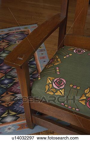 LIVING ROOM: Arts and Crafts style home, close up of oak arm chair, green embroidered seat cushion with stylized flowers View Large Photo Image Stock Photo - LIVING ROOM: Arts and Crafts style home, close up of oak arm chair, green embroidered seat cushion with stylized flowers. Fotosearch