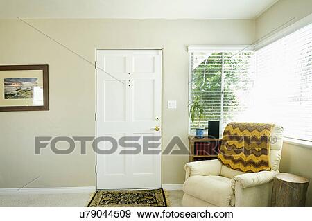 Living room with armchair by entrance door View Large Photo Image Stock Photo - Living room with armchair by entrance door. Fotosearch