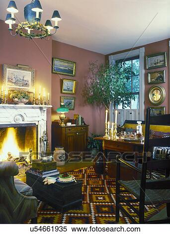 Stock Photography - LIVING ROOMS - American 19th Century house and furnishings, collections; Seascape paintings, crocks, carpenter boxes, fireplace with marble mantle. . Fotosearch