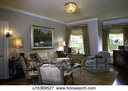 LIVING ROOMS: Traditional sitting area, special glaze painting Amour coat plaster paint on walls, painted cornices, gold drapes with soft folded shades, serene colors, window seat, crystal light fixture, View Large Photo Image Stock Photo - LIVING ROOMS: Traditional sitting area, special glaze painting Amour coat plaster paint on walls, painted cornices, gold drapes with soft folded shades, serene colors, window seat, crystal light fixture,. Fotosearch