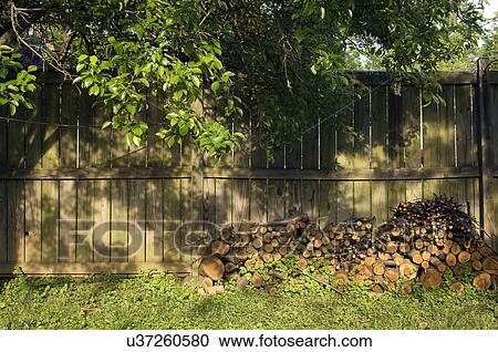 Log pile in backyard by wooden fence; Potomac; Maryland; USA View Large Photo Image Stock Image - Log pile in backyard by wooden fence; Potomac; Maryland; USA. Fotosearch