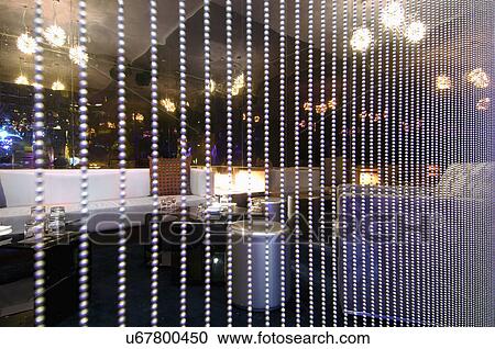 Stock Image - Lounge are behind beads in nightclub. Fotosearch