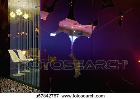 Stock Photo - Lounge area behind beads in nightclub. Fotosearch