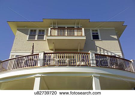 Stock Image - Low angle view of balcony in a single family home. Fotosearch