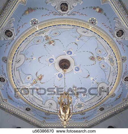 Low angle view of light fixture hanging on painted ceiling View Large Photo Image Stock Image - Low angle view of light fixture hanging on painted ceiling. Fotosearch