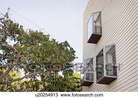 Stock Image - Low angle view of modern bay windows on side of home, San Diego, California, USA. Fotosearch