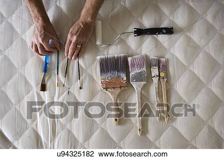 Male hand arranging painting tools on mattress View Large Photo Image Stock Image - Male hand arranging painting tools on mattress. Fotosearch