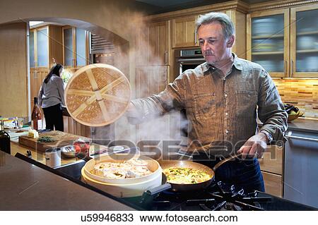 Man cooking in contemporary kitchen, Albuquerque, New Mexico, USA View Large Photo Image Stock Image - Man cooking in contemporary kitchen, Albuquerque, New Mexico, USA. Fotosearch