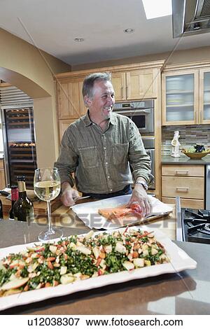 Man cooking in contemporary kitchen, Santa Fe, New Mexico, USA View Large Photo Image Stock Photo - Man cooking in contemporary kitchen, Santa Fe, New Mexico, USA. Fotosearch