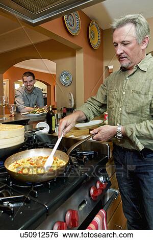 Man cooking in contemporary kitchen, Santa Fe, New Mexico, USA View Large Photo Image Stock Photograph - Man cooking in contemporary kitchen, Santa Fe, New Mexico, USA. Fotosearch