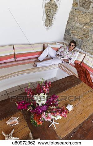 Man reading book on colorful bench, Mykonos, Greece View Large Photo Image Stock Image - Man reading book on colorful bench, Mykonos, Greece. Fotosearch