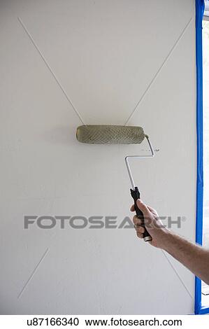 Man with roller in room prepared fro painting View Large Photo Image Stock Image - Man with roller in room prepared fro painting. Fotosearch