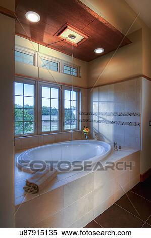 Stock Photography - Master bathtub that fills from the ceiling; Loxahatchee; Florida; USA. Fotosearch