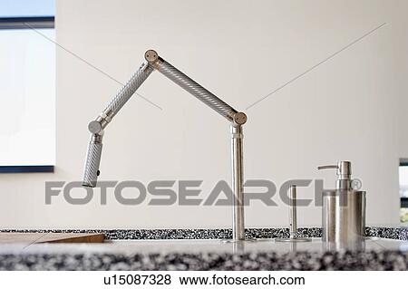 Stock Photo - Modern kitchen faucet, San Diego, California, USA. Fotosearch