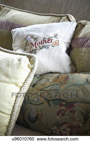 Stock Image - Mother's throw pillow on sofa; Carpinteria; California; USA. Fotosearch