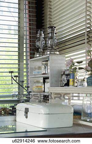 Oil lanterns on shelf by window blinds View Large Photo Image Stock Photograph - Oil lanterns on shelf by window blinds. Fotosearch