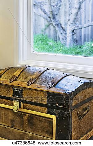 Stock Photo - Old brown trunk in front of window. Fotosearch