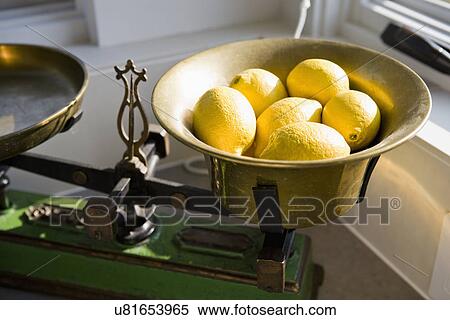 Stock Photography - Old kitchen scale with lemons; Hollywood; California; USA. Fotosearch