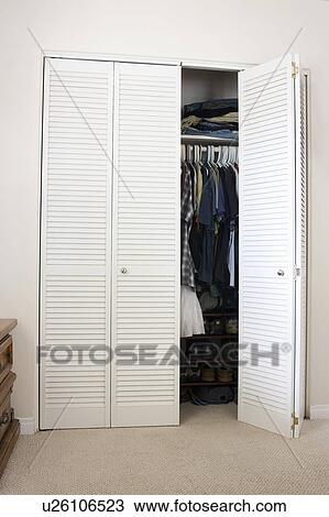 Open wardrobe door in domestic room View Large Photo Image Stock Image - Open wardrobe door in domestic room. Fotosearch