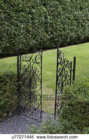 Stock Photography - Open wrought iron gate at entrance. Fotosearch
