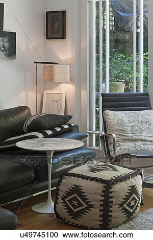 Stock Image - Ottoman and end table in traditional living room; Sydney; Australia. Fotosearch
