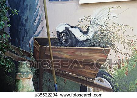 Picture - Outbuildings - Potting shed: Various detail shots of mural painted on outside of shed. Skunk playing in wheelbarrow.. Fotosearch
