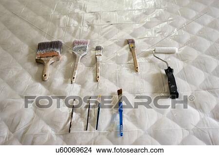 Picture - Painting tools arranged on mattress. Fotosearch