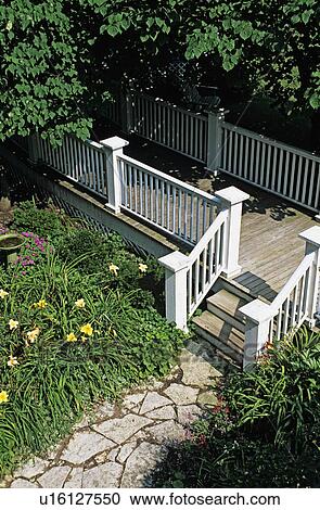 Patio: Flagstone walk leads to three steps up to fenced deck walkway. View Large Photo Image Stock Image - Patio: Flagstone walk leads to three steps up to fenced deck walkway.. Fotosearch