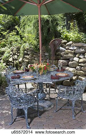 Patio Metal Patio Set Green Umbrella Rock Wall Behind Picture U65572014 Fotosearch