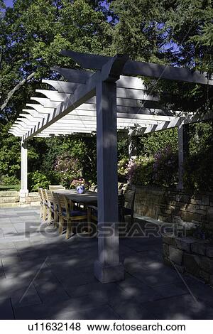 PATIO: pergola over dining area, waterfall behind View Large Photo Image Stock Photo - PATIO: pergola over dining area, waterfall behind. Fotosearch