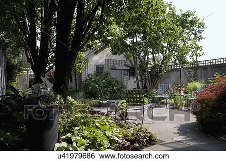 PATIOS: City garden, wood privacy fence, garage with lattice, border gardens around patio, small space View Large Photo Image Stock Photograph - PATIOS: City garden, wood privacy fence, garage with lattice, border gardens around patio, small space. Fotosearch