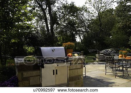 PATIOS: close up of Weber gas grill built into stone, patio dining to right, fall flowers, View Large Photo Image Stock Photo - PATIOS: close up of Weber gas grill built into stone, patio dining to right, fall flowers,. Fotosearch