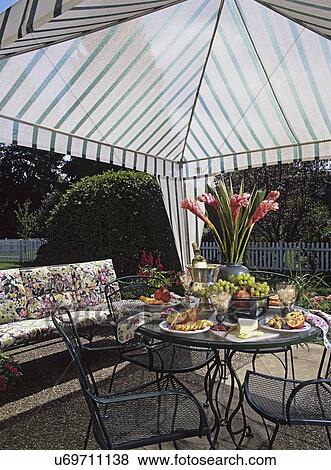 Stock Photo - PATIOS: Detail of table and food. Gazebo tent.. Fotosearch