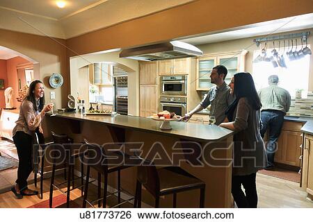 People visiting in contemporary kitchen, Albuquerque, New Mexico, USA View Large Photo Image Stock Photograph - People visiting in contemporary kitchen, Albuquerque, New Mexico, USA. Fotosearch