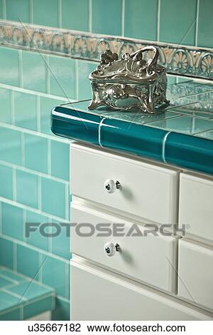 Pewter jewelry box on countertop in aqua tiled bathroom; Carpinteria; California; USA View Large Photo Image Stock Image - Pewter jewelry box on countertop in aqua tiled bathroom; Carpinteria; California; USA. Fotosearch