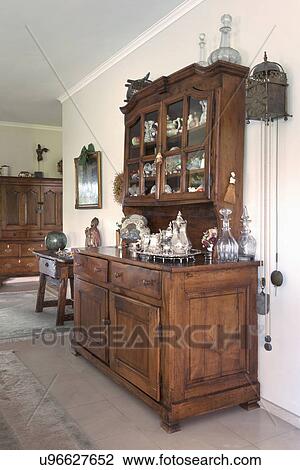 Stock Image - Pewter tea set on wooden hutch. Fotosearch