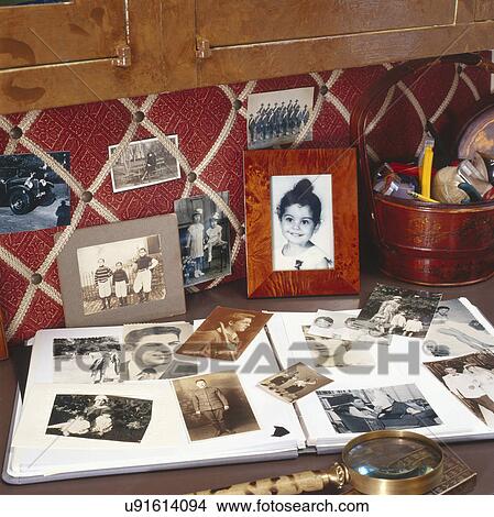 Photographs and scrapbook on counter View Large Photo Image Picture - Photographs and scrapbook on counter. Fotosearch