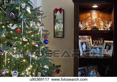 Picture Of Frames In Shelf By Decorated Christmas Tree Picture Of Frames In Shelf By Decorated Christmas Tree