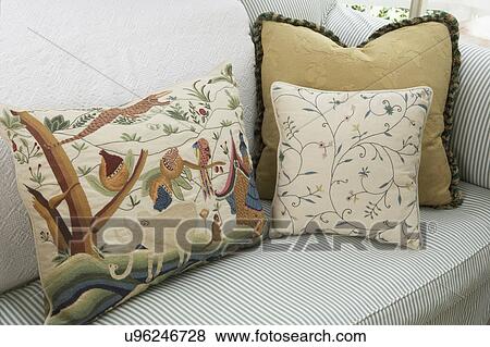 Pillows: Green and white cotton ticking sofa with mixed fabric throw pillows, tapestry, floral and tone on white brocade View Large Photo Image Stock Photo - Pillows: Green and white cotton ticking sofa with mixed fabric throw pillows, tapestry, floral and tone on white brocade. Fotosearch