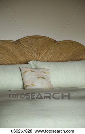 Stock Photo - Pillows on bed with wooden headboard; Carpinteria; California; USA. Fotosearch
