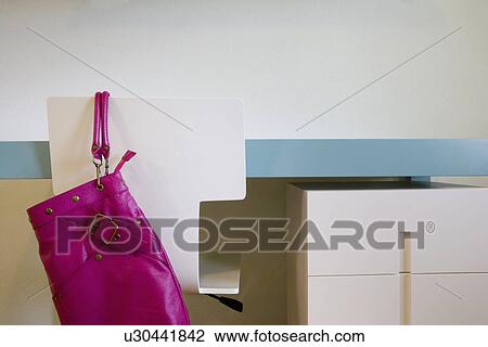 Pink purse hanging off back of modern desk chair; Aliso Viejo; California; USA View Large Photo Image Stock Image - Pink purse hanging off back of modern desk chair; Aliso Viejo; California; USA. Fotosearch