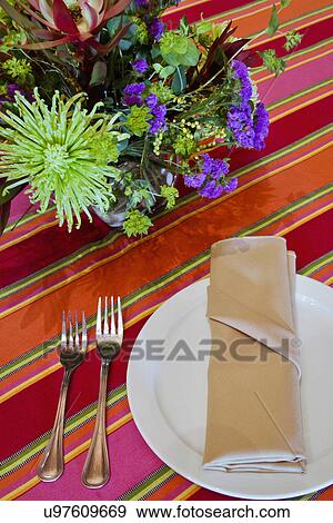 Stock Photo - Place setting on colorful table cloth, Ojo Caliente, New Mexico, USA. Fotosearch