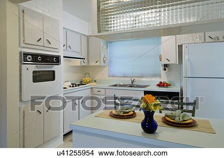 Picture - Place settings at breakfast bar in retro kitchen. Fotosearch