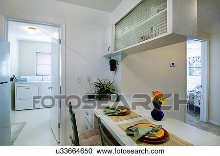 Place settings at breakfast bar outside laundry room View Large Photo Image Stock Image - Place settings at breakfast bar outside laundry room. Fotosearch