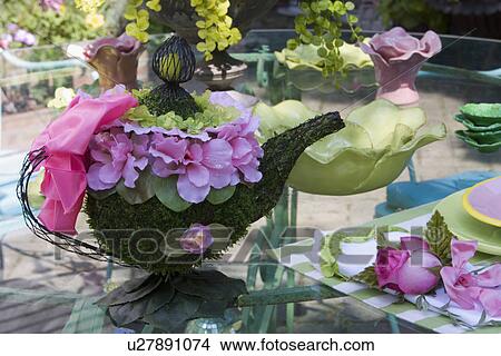 Picture - PLACE SETTINGS: cottage chic style place settings, silk floral teapot, colorful pink and green pottery outdoor dining. Fotosearch