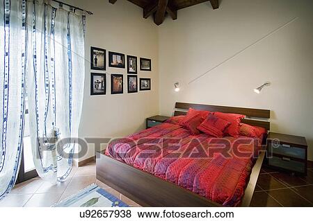 Platform bed with red comforter; Italy View Large Photo Image Stock Photo - Platform bed with red comforter; Italy. Fotosearch