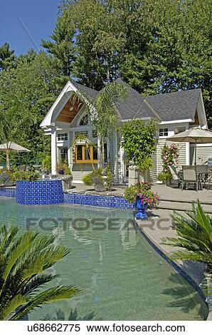 Stock Photography - Pool house by swimming pool. Fotosearch